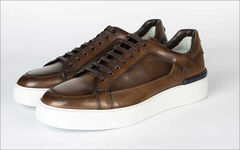 Brown leather shoes with realistic shadow