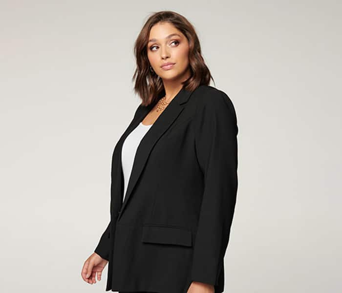Woman wearing a black blazer before clipping path service